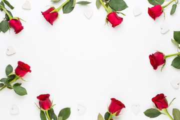 Flowers composition. Frame made of red rose on white background. Flat lay, top view, copy space.