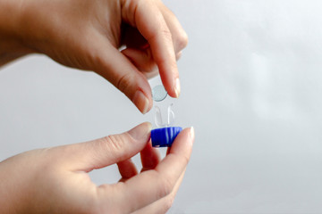 Background of chemical colored liquids in big flasks. Transparent liquid with precipitate and blue reagent 