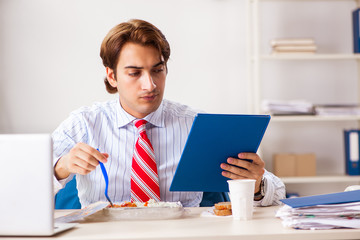 Man having meal at work during break