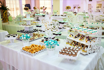candy bar decorated by delicious sweet buffet with cupcakes and other desserts/candies,happy birthday concept