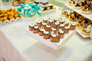 candy bar decorated by delicious sweet buffet with cupcakes and other desserts/candies,happy birthday concept