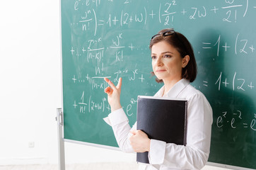 Female math teacher in front of the chalkboard 