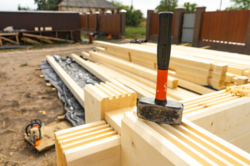 Construction of the house from a bar. Drilling holes and clogging of dowels.