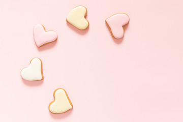 Fototapeta premium Composition Valentine's Day. Ginger cookie in shape heart on pastel pink background. Valentine day concept, design.