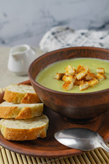 Fresh healthy cream soup with spinach, cream and croutons