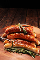 Grilled sausages with spices on a wooden table - Home-made Pork Sausages
