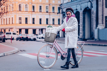 Fototapeta premium Positive delighted girl walking with pleasure alone