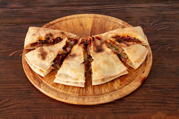Pizza calzone on the textured table, for the restaurant menu, cafe, advertising.