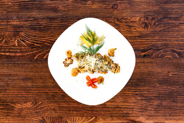 Seafood on a plate on a wooden table, a dish for the menu and advertising.