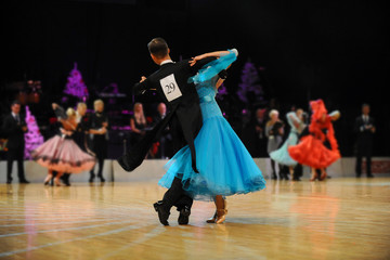 young couple athletes dancers competition in ballroom dancing