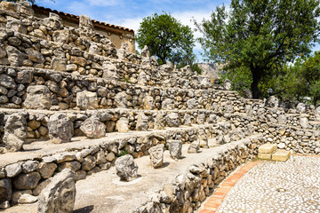 Rows of heads carved on the rocks at Enchanted Castle (Castello Incantato) open-air museum, Sciacca, Sicily, Italy