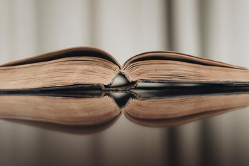 ancient book shot on brown background. The book is in bad condition.
