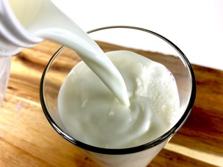 Pouring a glass of milk 