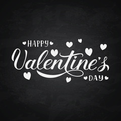 Happy Valentine’s Day calligraphy lettering on chalkboard background.  Hand drawn celebration poster.