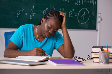 Black female student in front of chalkboard  