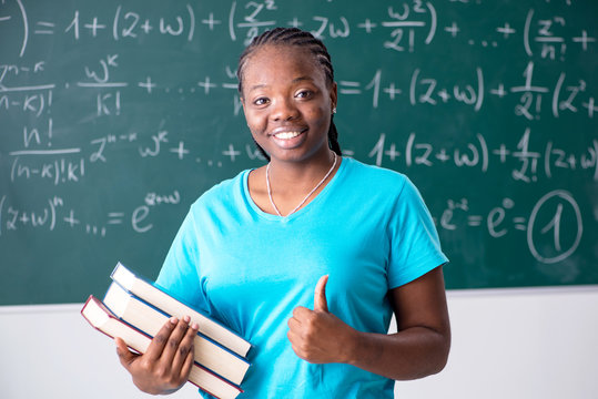 Black Female Student In Front Of Chalkboard  