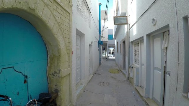 Ancient narrow street in central Monastir. Tunisia. Old town. 4K.