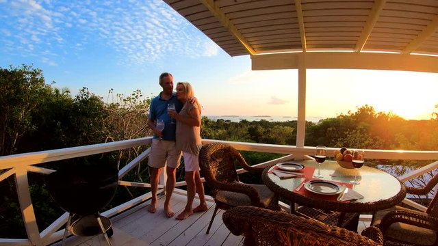 Retired Caucasian couple on terrace at sunset Bahamas