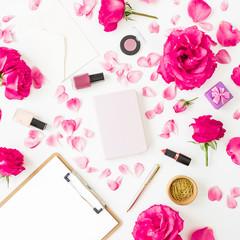 Obraz na płótnie Canvas Beauty concept with cosmetics - lipstick, eye shadows, nail polish, pink roses and clipboard and notebook on white background. Flat lay, top view.