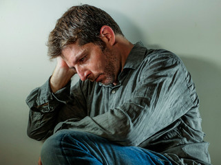 isolated background portrait of 30s to 40s sad and depressed man looking thoughtful and worried suffering depression problem with dramatic face expression