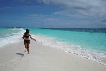 Fototapeta na wymiar Asian woman in bikini enjoying a beach in the Maldives