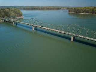 Fototapeta na wymiar An aerial view of Browns Bridge road as it crosses the green waters of Lake Lanier in northern Georgia.