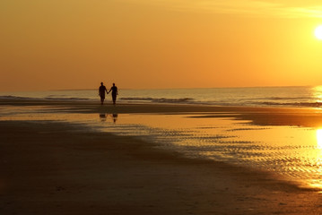 Fototapeta na wymiar Couple Walking on Beach Silhouette