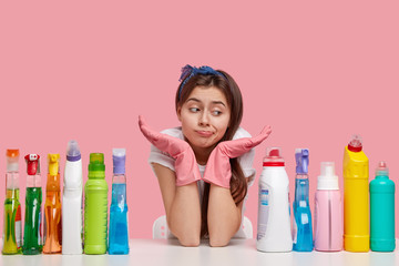 Clueless Caucasian dark haired young woman wears headband, spreads palms, feels apathy towards...