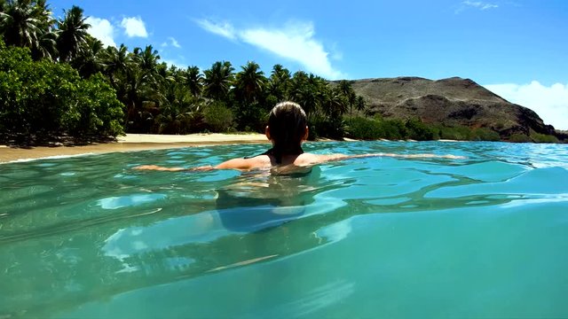 Female on a deserted Island beach Tahuata Marquesas