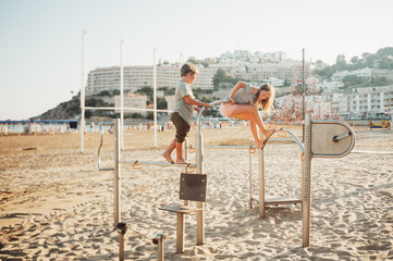 Fototapeta na wymiar Two kids having fun on beach playground, summer vacation