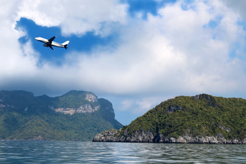 Fototapeta na wymiar Airplane in the sky with white clouds and blue sky at samui island