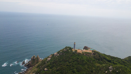 Aerial view of Dai Lanh beach and Mui Dien light house in a sunny day, MuiDien, Phu Yen province - The eastermost of Vietnam. Stock image top view of Mui Dien lighthouse on fractured rocky cliff 