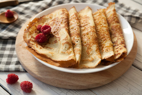 Pancakes Thin homemade pancakes with berries, traditional Russian cuisine. Homemade pancakes with berries