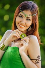 Beautiful young asian woman with slice of kiwi