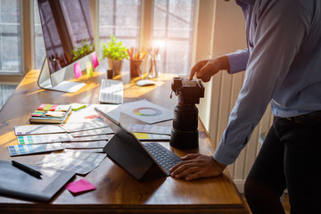 Young creative designer choosing photo from his camera for design project.Brainstorming Planning Partnership concept