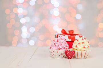 Cupcakes with heart and fairy lights. Empty space for text. Valentine day concept