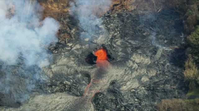 Aerial view of active volcanic activity destroying trees