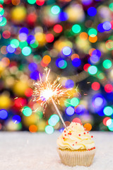 Christmas cupcake decorated with sparkler. Empty space for text