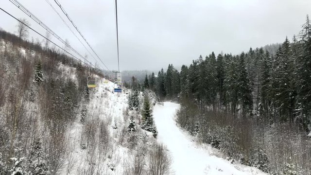 View from the chair to the chair lift at a ski resort in winter.