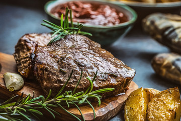 Beef grilled steaks with barbecue sauce roasted potatoes and rosemary