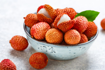 Fresh organic lychee fruit in a bowl.