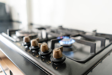 Closeup shot of blue fire from domestic kitchen hob. Gas cooker with burning flames propane gas.