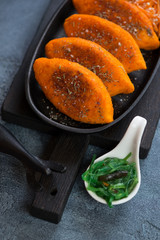 Close-up of roasted cutlets made of carrot, vertical shot, selective focus