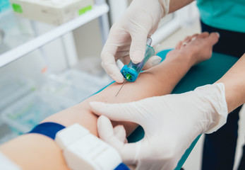 Nurse taking a little child blood sample. Medical equipment.