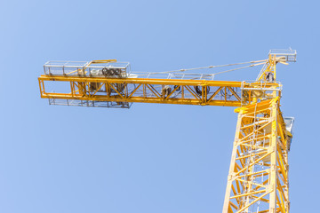 Yellow crane in daylight. Building technologies. Modern construction crane