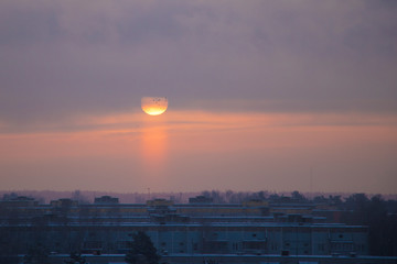 The sun rises on a frosty misty morning over the city.