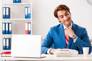 Man having meal at work during break