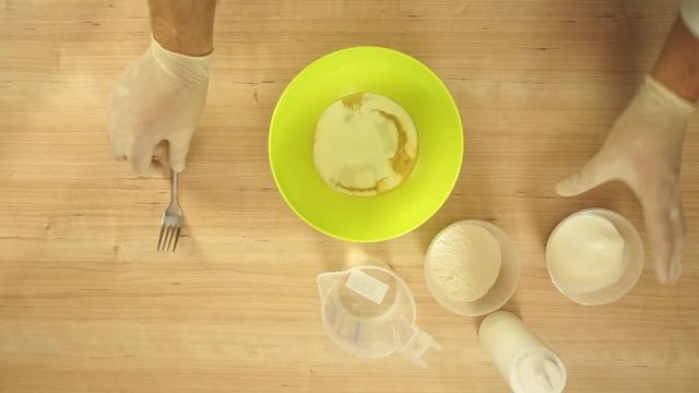 Chef is mixing dough for pancakes, time lapse top view