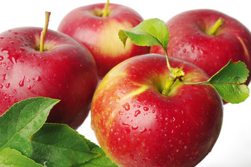 Red apples with leaves on white background