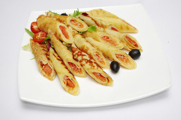 Pancakes with meat on a white plate